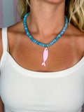 Blue beaded necklace with pink fish charm